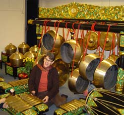 Sara Weiss sitting with gamelan suprabanggo instruments